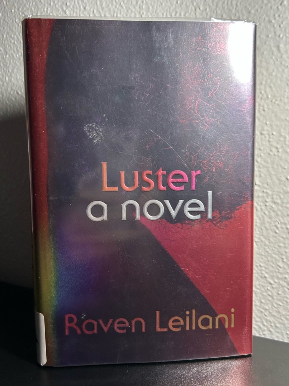 Luster by Raven Leilani - Hardcover Novel in Red and Iridescent Cover